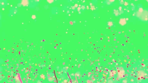 Colorful confetti and streamers falling slowly against a bright green Video stock 338995285