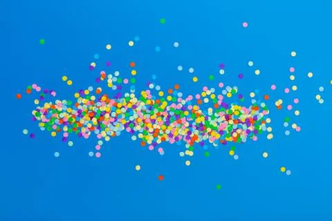 Colorful confetti on blue background. Stock Photos