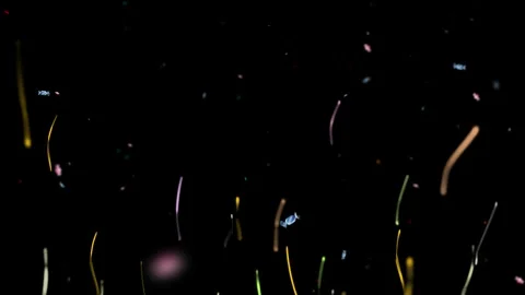 Colorful confetti falling on black background. Festive party streamers for Video stock 340381267