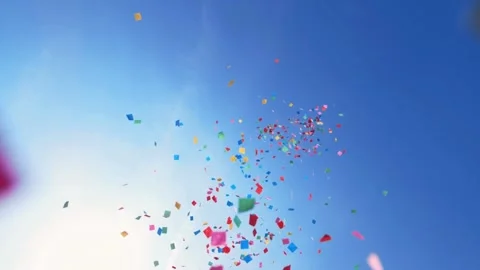 Colorful confetti falling from the sky in sunshine Stock Footage 266994341