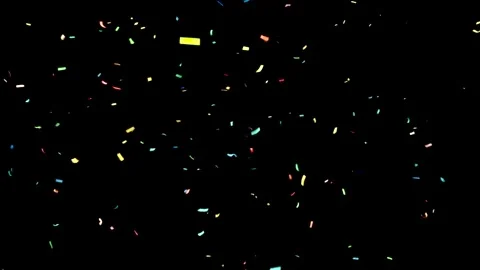 Colorful confetti floating in the dark during a nighttime party Stock Footage 295156563