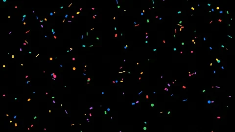 Colorful confetti particles falling and floating slowly against a solid black Video stock 345430215