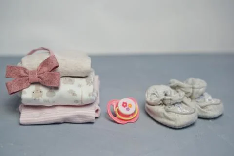 Colorful cotton folded clothes stack on white table empty space background,baby Stock Photos