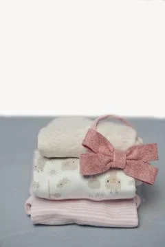Colorful cotton folded clothes stack on white table empty space background,baby Stock Photos