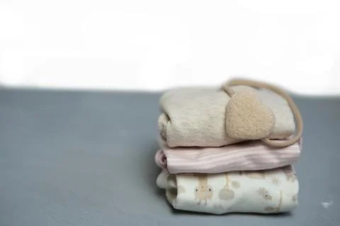 Colorful cotton folded clothes stack on white table empty space background,baby Stock Photos