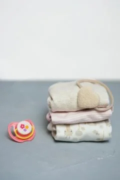 Colorful cotton folded clothes stack on white table empty space background,baby Stock Photos