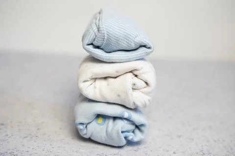 Colorful cotton folded clothes stack on white table empty space background,baby Stock Photos