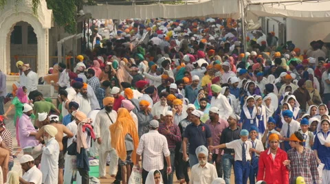 Colorful crowds visit the Golden Temple in Amritsar, India Stock Footage