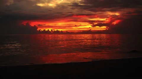 Colorful dawn in dark clouds on the beach. Stock Footage 142254367