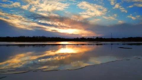 Colorful dawn sky reflected in the thin ice of a new day Stock Footage 295303017