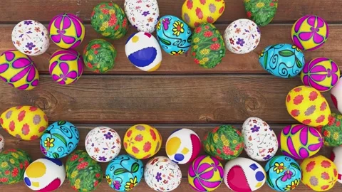 Colorful decorated Easter eggs creating frame border on rustic wooden background Stock Footage 299497370
