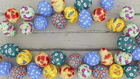Colorful decorated Easter eggs creating frame border on rustic wooden background Video stock 299497372