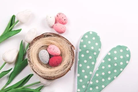 Colorful decorations with Easter egg nest with spring flowers on white Stock Photos