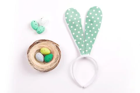 Colorful decorations with Easter egg nest and rabbit ears on white background Stock Photos