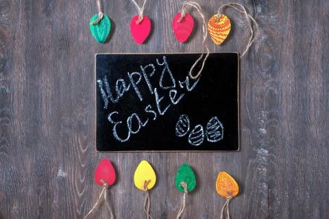 Colorful decorative Easter eggs made of paper on a wooden background. Top v.. Stock Photos