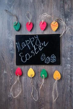 Colorful decorative Easter eggs made of paper on a wooden background. Top v.. Stock Photos