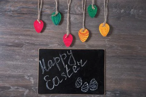 Colorful decorative Easter eggs made of paper on a wooden background. Top v.. Stock Photos