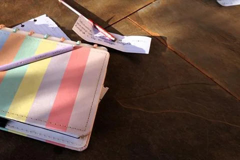 Colorful diary thrown on the floor in coded writing Stock Photos