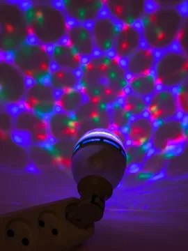 Colorful disco light pattern with bulb Stock Photos