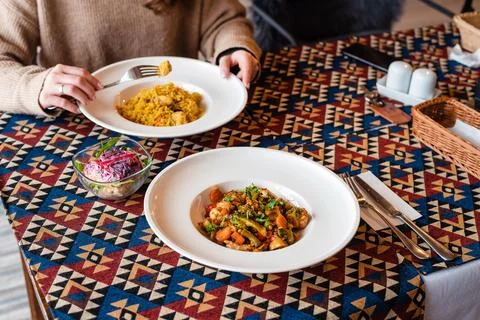 Colorful Dishes on Patterned Tablecloth Stock Photos