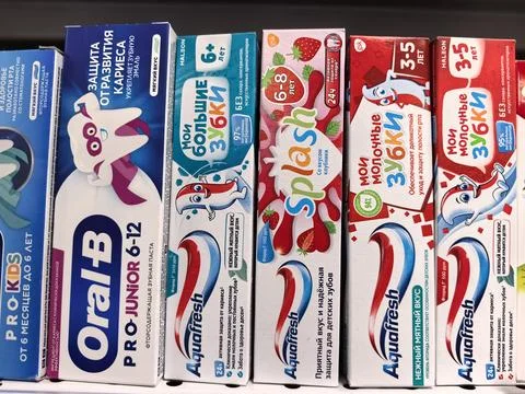Colorful display of children's toothpaste options in a vibrant store Фото