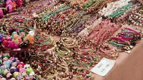Colorful display of handmade beaded bracelets at a market or souvenir stall. 動画素材 314452445