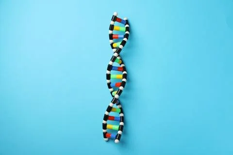 Colorful DNA structure model on light blue background, top view 写真素材