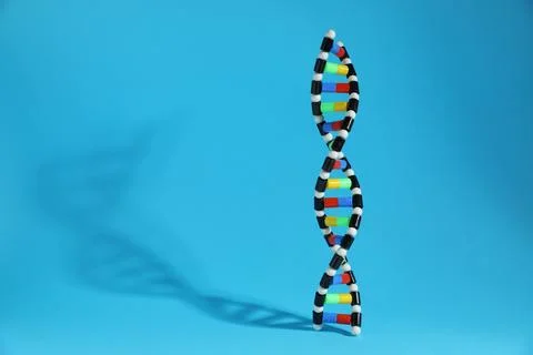 Colorful DNA structure model on light blue background. Space for text 스톡 사진