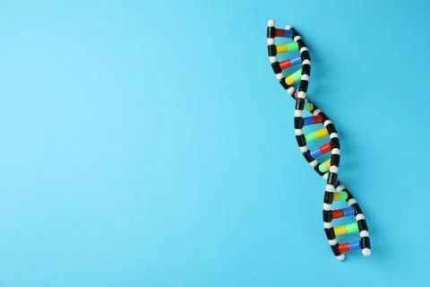 Colorful DNA structure model on light blue background, top view. Space for te 写真素材