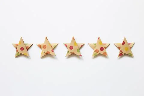 Colorful dot pattern brown five stars quality rating on white background Stock Photos