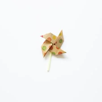 Colorful dot pattern brown paper pinwheel isolated on white background 스톡 사진
