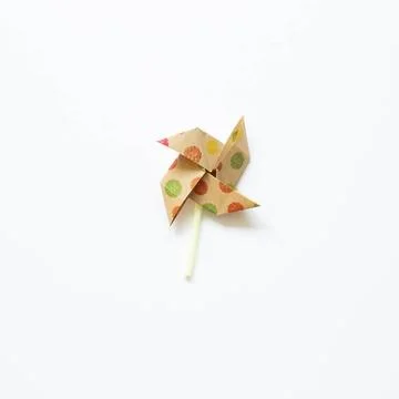 Colorful dot pattern brown paper pinwheel isolated on white background. to... Stock Photos