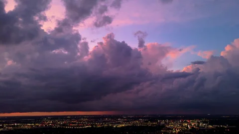 Colorful dramatic blue sky with dark purple red rainy clouds at sunset evening Stock-Footage 317734493