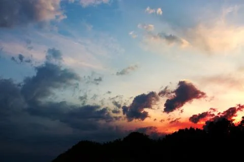 Colorful dramatic sky with big clouds at sunset. Stock Photos