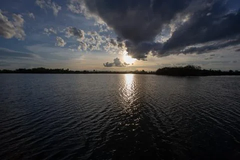 Colorful dramatic sky with cloud on the river under the sunset Stock Photos