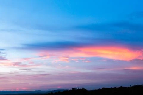 Colorful dramatic sky with cloud at sunset. Stock Photos