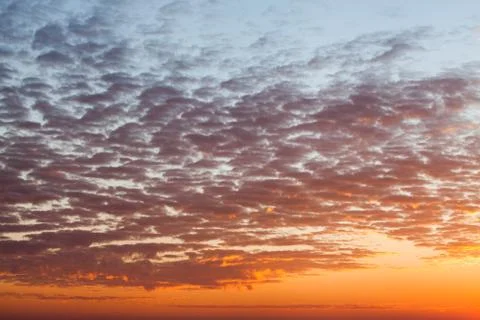 Colorful dramatic sky with cloud at sunset. Stock Photos