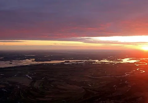 Colorful dramatic sky with cloud at sunset over Dnipro river and fields Stock Photos