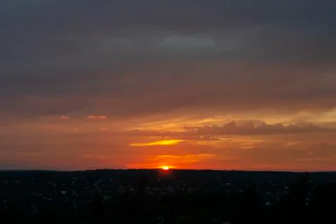 Colorful dramatic sunset with cloudy sky Stock Photos