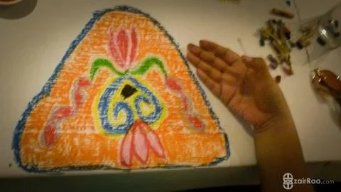 Colorful drawing of a triangle with patterns next to hand Foto stock