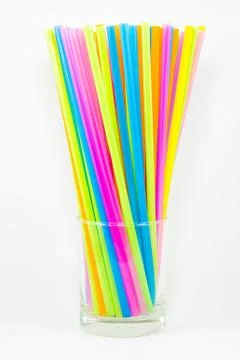 Colorful drinking straws in glass isolated on white background Stock-Fotos