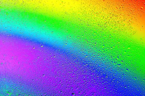 Colorful droplets create a stunning rainbow effect on a misty surface in su.. Stock Illustration