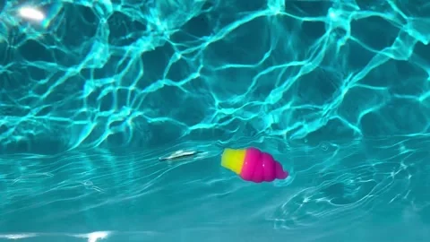 Colorful dumpling shaped squishy stress relief toy floating in pool in 4K Stock Footage 340609159