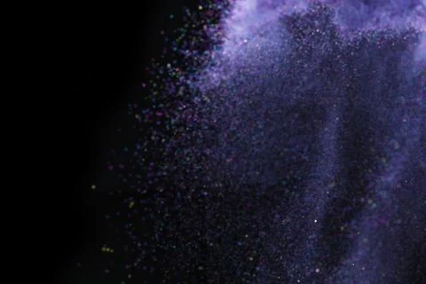 Colorful dust explode at black background. Celebrate Indian Holi festival of  Stock Photos