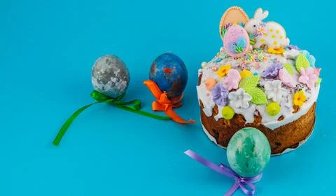 Colorful Easter cake with decorated eggs on bright background Stock Photos