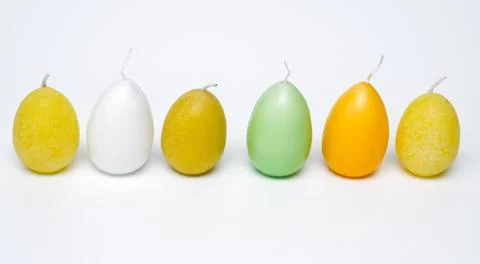 Colorful Easter candles lined up in a row Stock Photos