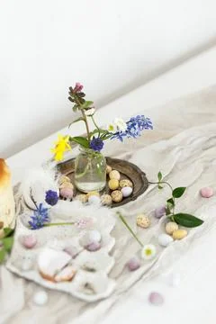 Colorful easter chocolate eggs, easter bread, spring flowers and linen clot.. Stock Photos