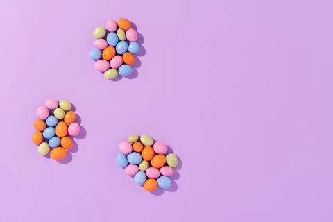 Colorful easter dragee on a violet background Stock Photos