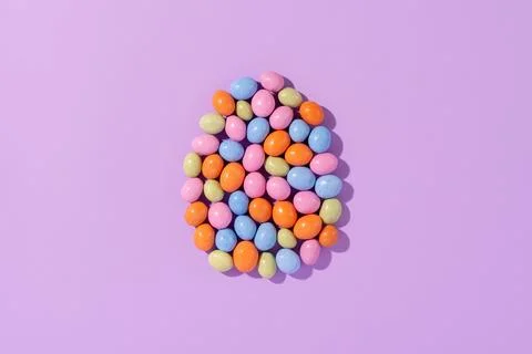 Colorful easter dragee on a violet background Stock Photos