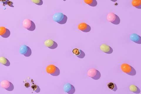 Colorful easter dragee on a violet background Stock Photos